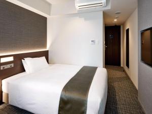 Ένα ή περισσότερα κρεβάτια σε δωμάτιο στο Hotel Keyaki Gate Tokyo Fuchu