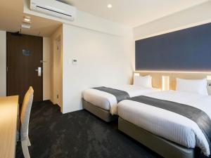 Ένα ή περισσότερα κρεβάτια σε δωμάτιο στο Hotel Keyaki Gate Tokyo Fuchu