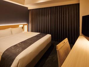Ένα ή περισσότερα κρεβάτια σε δωμάτιο στο Hotel Keyaki Gate Tokyo Fuchu