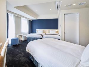 Ένα ή περισσότερα κρεβάτια σε δωμάτιο στο Hotel Keyaki Gate Tokyo Fuchu