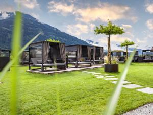 a row of luxury tents in a grassy field at Sport- und Wellnesshotel Held 4 Sterne Superior in Fügen