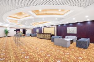 a large room with couches and chairs and a stage at Holiday Inn Beijing Chang An West, an IHG Hotel in Beijing
