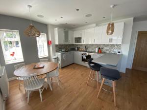 a kitchen and dining room with a table and chairs at The Hideout in Anderby
