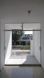 a room with a large glass door and a window at Departamento Mapy en Piura in Piura
