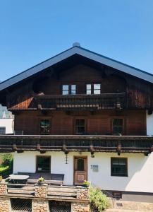 a large wooden house with a gambrel roof at Ferienhaus Anna in Zell am Ziller