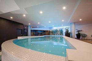 a large swimming pool in a building at Luxe 2BR Executive Apartment Kingston Pool Parking WiFi BBQ Wine in Kingston 