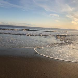 a beach with waves coming in from the ocean at The Hideout in Anderby