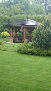 a gazebo in a park with green grass at Willa Oaza Na Wzgórzu in Cieszyn