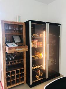 a refrigerator filled with lots of bottles and alcohol at Haus Pannonsee in Podersdorf am See
