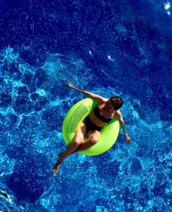 a man in a swimming pool with a frisbee at Complex Karia II in Kavarna