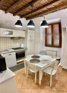 a kitchen with a white table and white appliances at Rome center apt in Rome