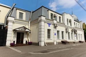 a large white building on the side of a street at Hotel Lermontov in Omsk