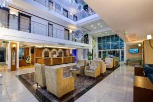 a lobby with chairs and a bar at Sealife Family Resort Hotel in Antalya +37 photos