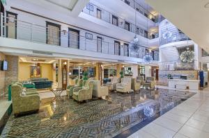 a lobby with couches and chairs in a building at Sealife Family Resort Hotel in Antalya