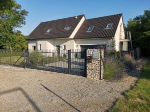 une maison avec un portail et une clôture dans l'établissement Ubytování Tři Vrby, à Pasohlávky