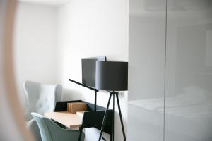 a table and chairs in a room with white walls at KRACHER Guesthouse No 7 in Illmitz