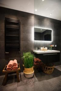 a bathroom with a sink and a mirror at LOFT 188 Luxury Apartment Hotel in Utrecht