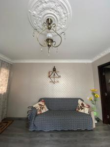 a living room with a couch and a chandelier at Home in batumi in Batumi