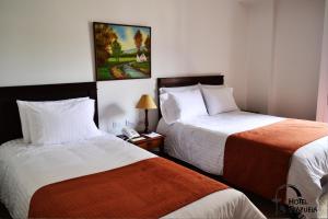 Un pat sau paturi într-o cameră la Hotel La Plazuela