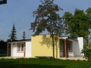 a small house with a tree in front of it at Ośrodek Wypoczynkowy Perkoz in Okuninka