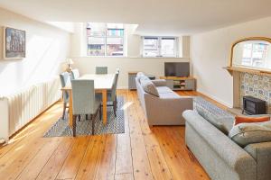 a living room with a table and a couch at Mary Lyth - Whitby West Cliff with parking in Whitby