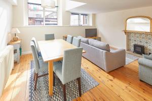 a living room with a table and chairs and a couch at Mary Lyth - Whitby West Cliff with parking in Whitby