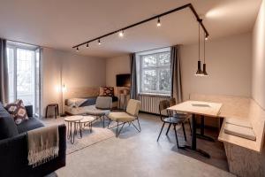 a living room with a couch and a table at Belmont- Apartment Haus in Arosa