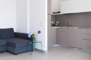 a living room with a couch and a table with flowers at Majson EJ in Civitanova Marche