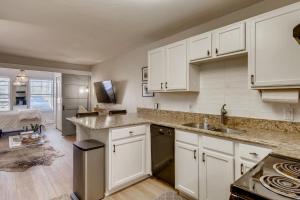 a kitchen with white cabinets and a sink at First Tracks 3105 condo in Steamboat Springs
