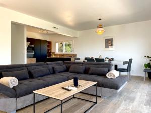 a living room with a couch and a table at villa I Cresti proche centre ville et plages in Ajaccio