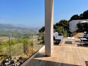 a patio with a view of the valley from a house at villa I Cresti calme confort emplacement idéal et tres belle vue in Ajaccio