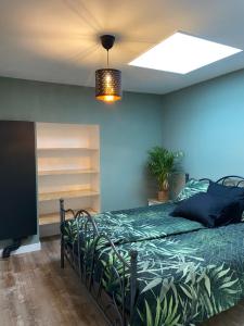 a bedroom with a bed and a television in a room at Appartement aan de Mergelgrot -Cauberg Valkenburg in Valkenburg