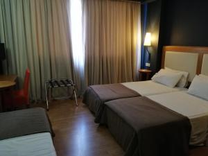 Postel nebo postele na pokoji v ubytování Olympic Hotel