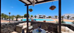 a patio with a view of a swimming pool at Casa Aitana in Puerto Calero