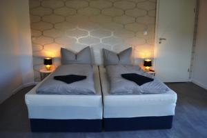 a large white bed with two pillows on it at Ferienwohnung Klüger in Liebstadt