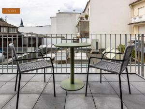 a table and two chairs on a balcony at limehome Osnabrück Johannisstraße in Osnabrück