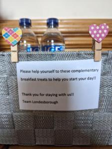 a sign in a bag with two bottles of water at The Londesborough Arms bar with en-suite rooms in Market Weighton