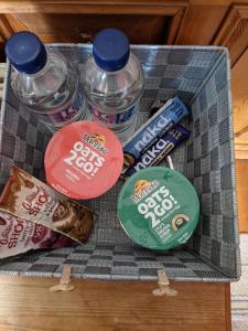 a tray of snacks and water bottles on a table at The Londesborough Arms bar with en-suite rooms in Market Weighton