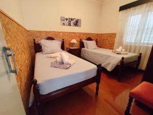 En eller flere senge i et værelse på Casa da Tia Maria