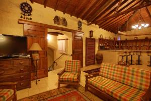 a living room with a couch and a tv at Hotel Surban - Special Category in Ürgüp