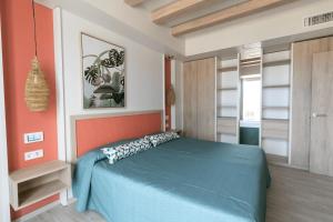 a bedroom with a blue bed and an orange wall at The White Apartments in San Antonio