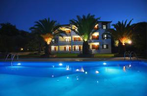 a large house with a swimming pool at night at Villa Maro in Skopelos Town
