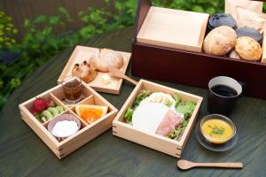 two wooden boxes filled with different types of food at Bed and Craft KIN-NAKA in Inami