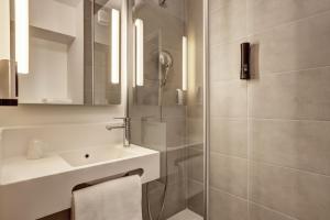 a bathroom with a sink and a shower at B&B HOTEL Evian Publier in Publier