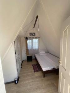 a small bedroom with a bed in a attic at Casute tip A costinesti in Costinesti