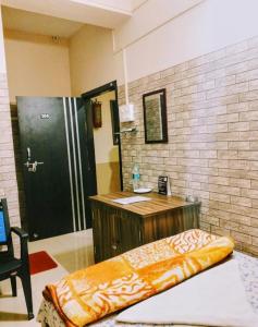 a bathroom with a shower and a wooden desk at D.D Lodge in Guwahati