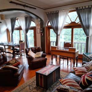 a living room with a couch and a piano at B&B Il Santo Pellegrino in Adrara San Rocco