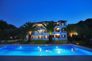 a large house with a swimming pool at night at Villa Maro in Skopelos Town +24 photos