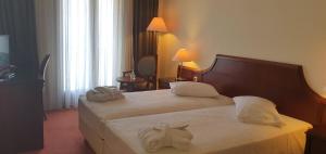 Uma cama ou camas num quarto em Hotel Apollonia Delphi