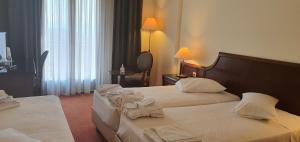 Uma cama ou camas num quarto em Hotel Apollonia Delphi